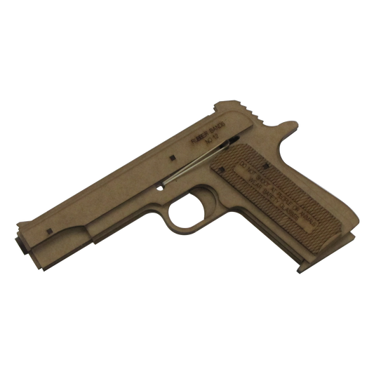 A wooden rubber band gun modeled after the classic 1911 pistol design. The gun features engraved text on the side, including safety warnings and the recommended rubber band size ('No. 12'). It is made from laser-cut wood panels with a visible trigger and rubber band notches, emphasizing its handcrafted and toy-like nature.