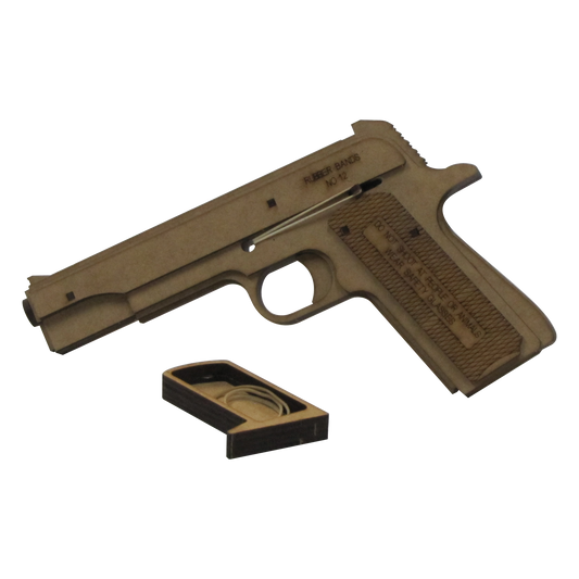A wooden rubber band gun modeled after a 1911 pistol, shown with its removable magazine tray exposed. The tray, positioned below the grip, contains spare rubber bands. Engraved safety warnings and the recommended rubber band size ('No. 12') are visible on the side of the gun, which is constructed from laser-cut wood with a functional trigger and loading mechanism.
